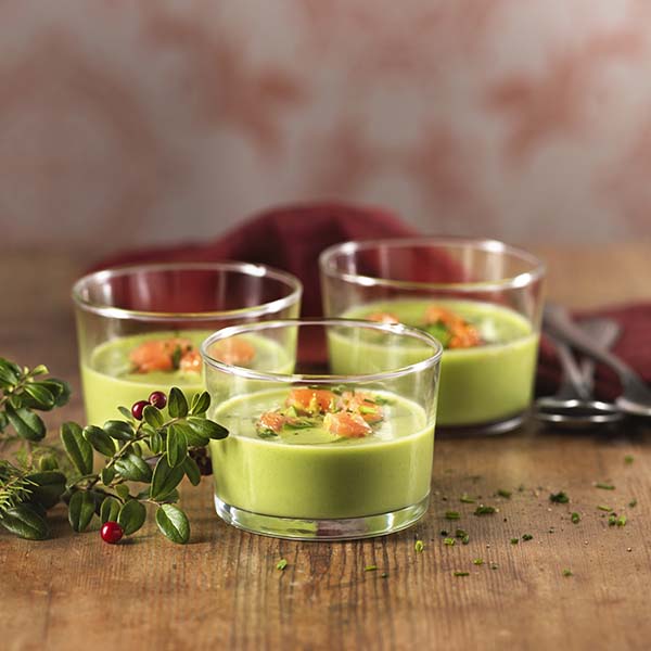 Tre vide glass med grønn ertesuppe med kokosmelk, og røkt laks som garnityr